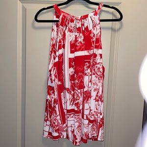 Woman’s red and white flowered tank top with Silver by the neckline.